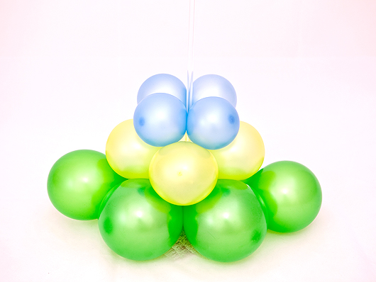  Надуваем голубые воздушные шары и закрепляем их на стойке над жёлтыми и зелёными воздушными шарами 